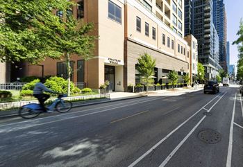 A cyclist rides down a tree-lined street at Chateau on Wells, Illinois